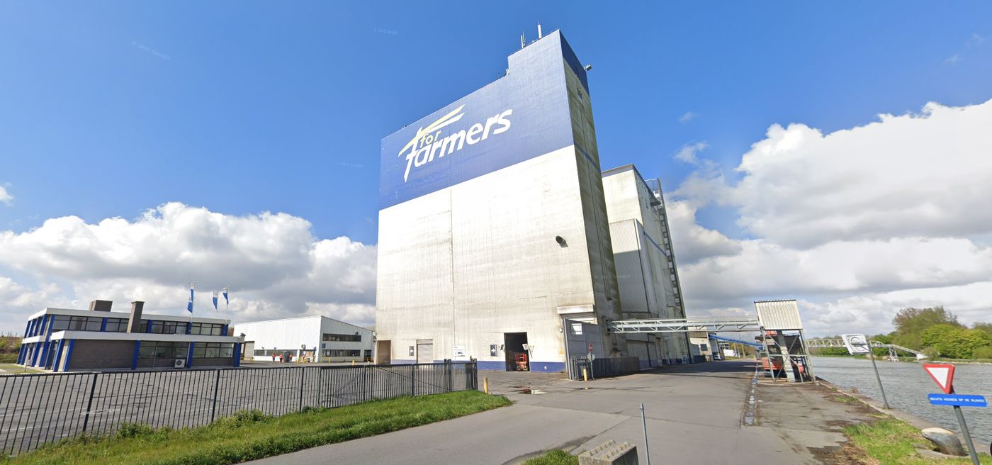 Hoog silogebouw met kantoren langs een kanaal